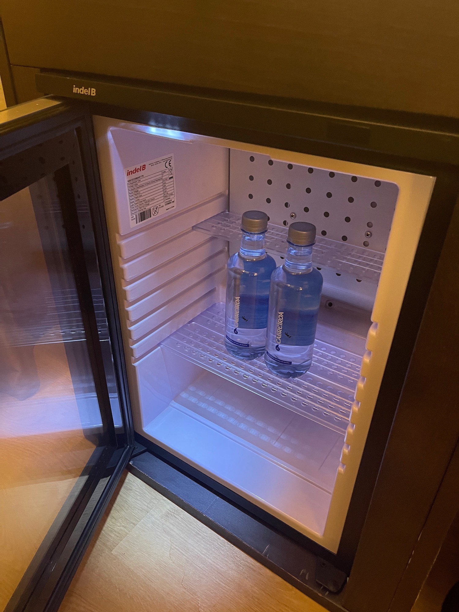 two bottles of water inside a mini fridge