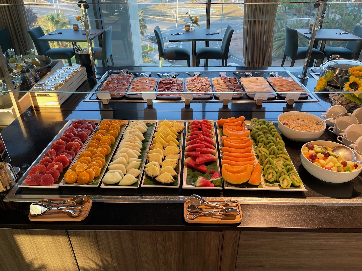 a buffet table with different types of fruit on trays