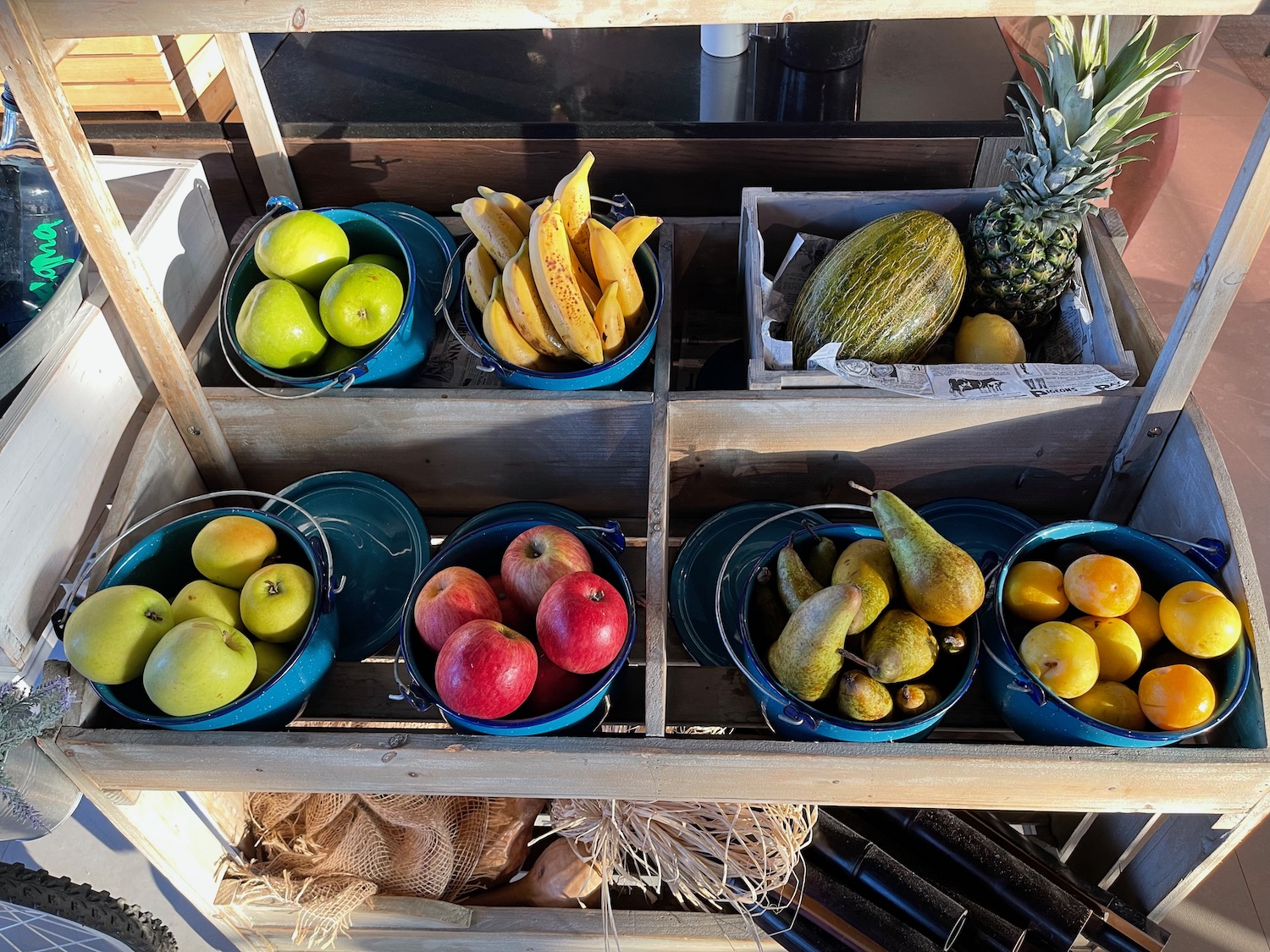 a shelf with bowls of fruit