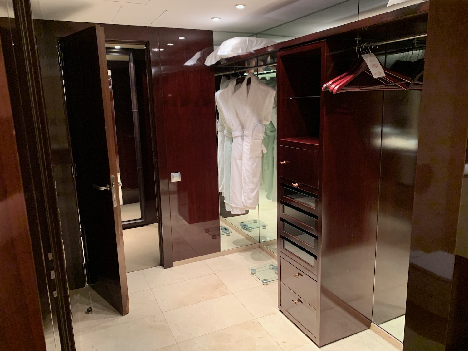 a closet with white robes in it