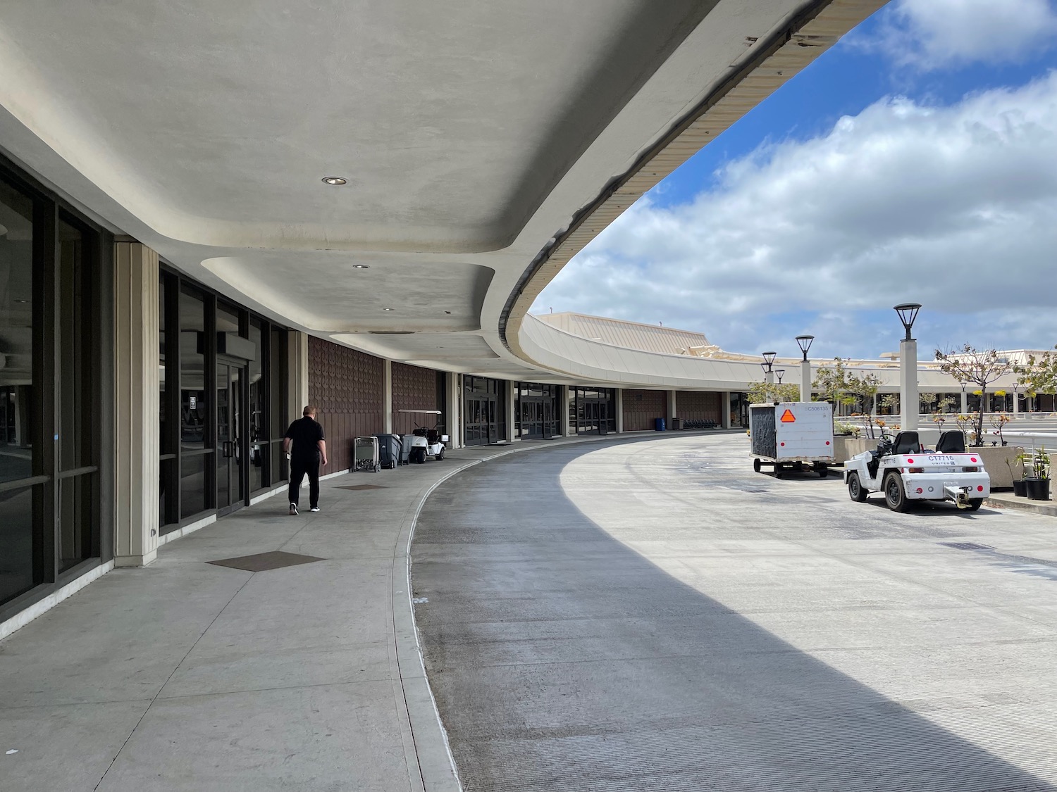 a curved walkway with a person walking on it