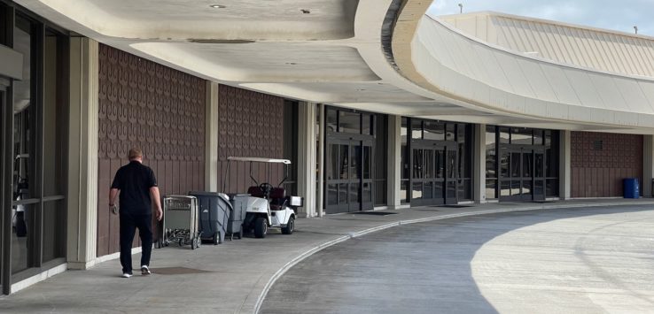 a man walking on a sidewalk