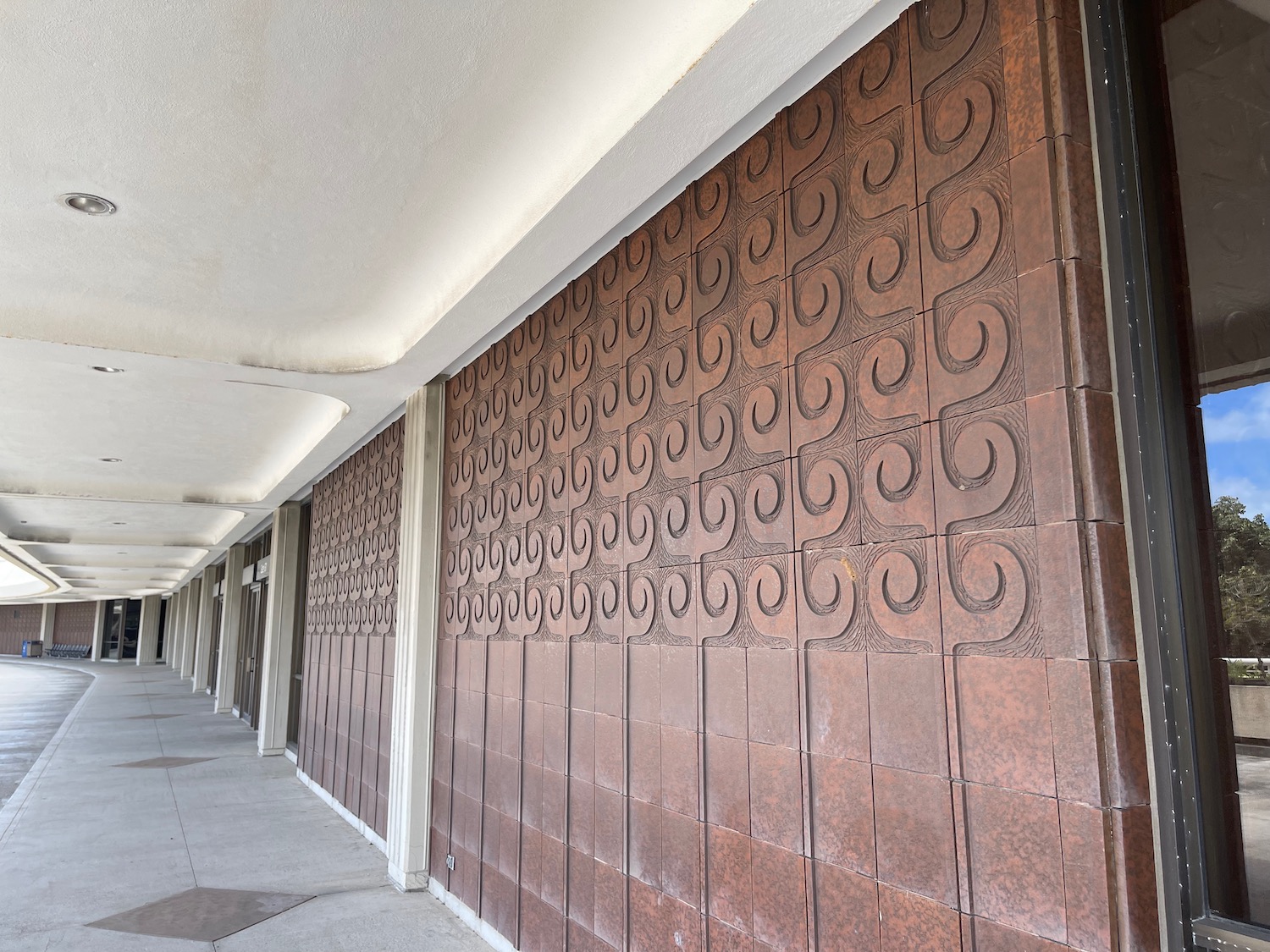 a long corridor with a wall with a pattern on it