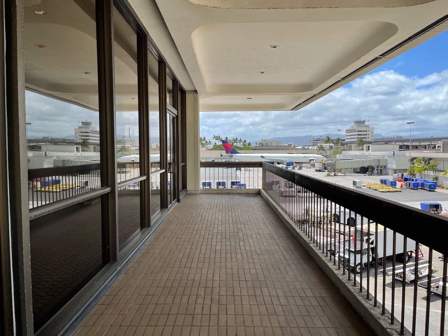 a balcony with a plane in the background