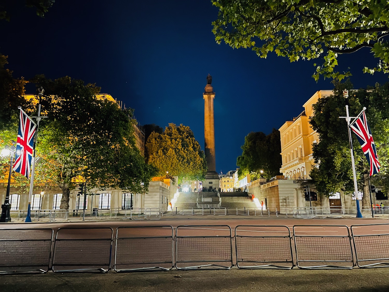 a city street with a tall tower and trees