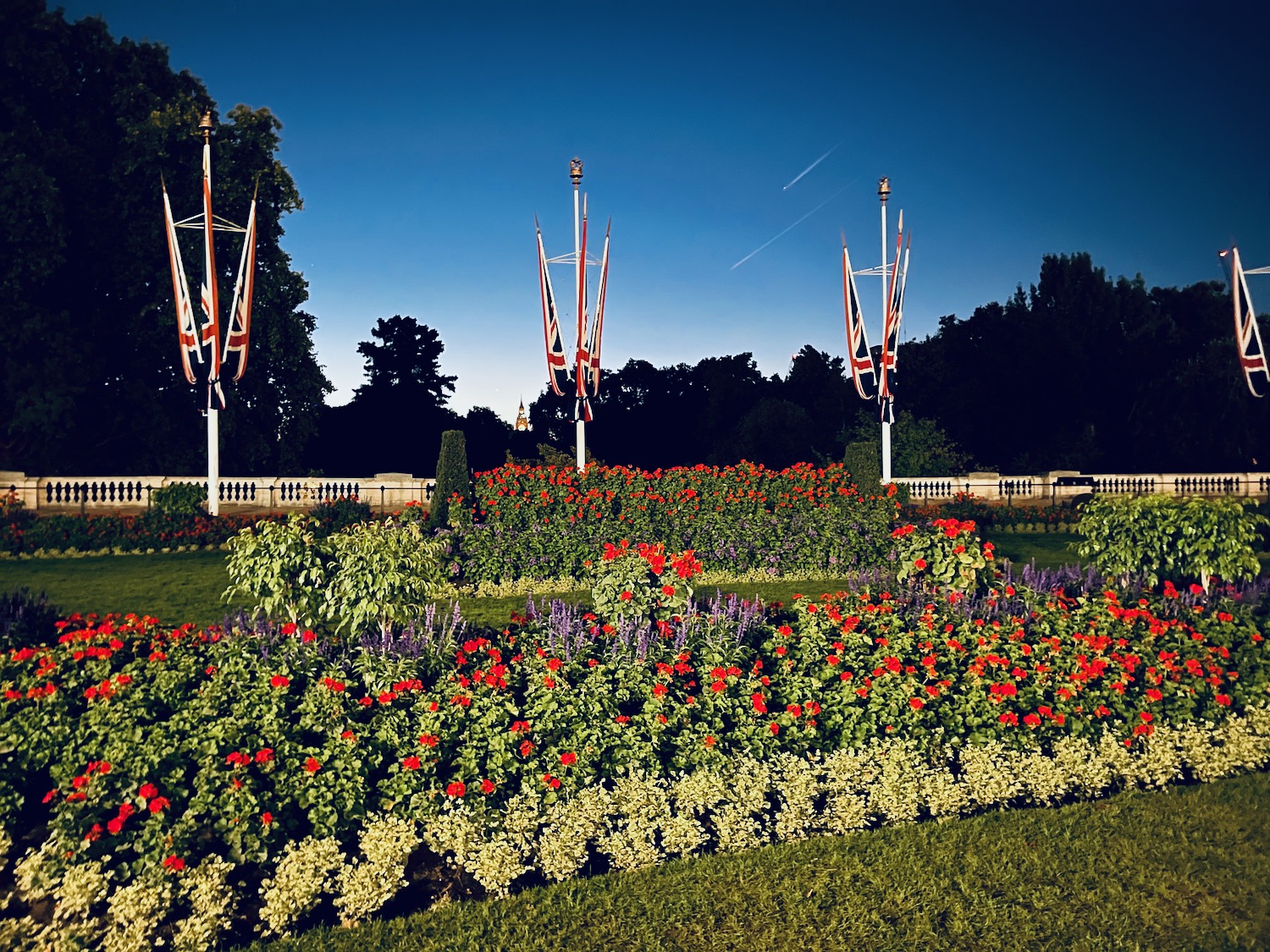 a garden with flags and flowers