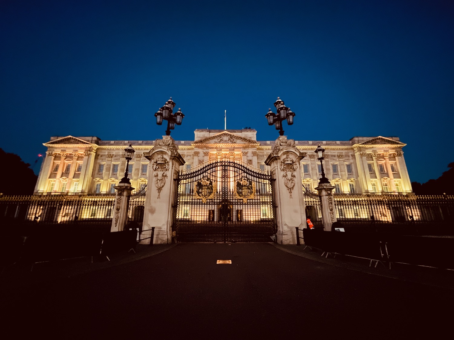 a large building with a gate and lights