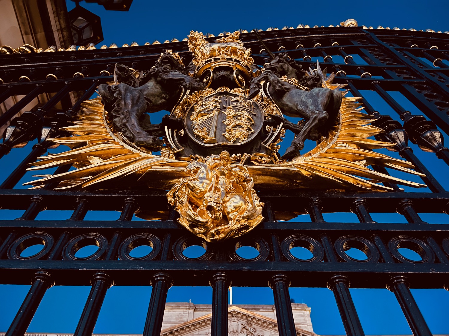 a black and gold gate with a gold crest