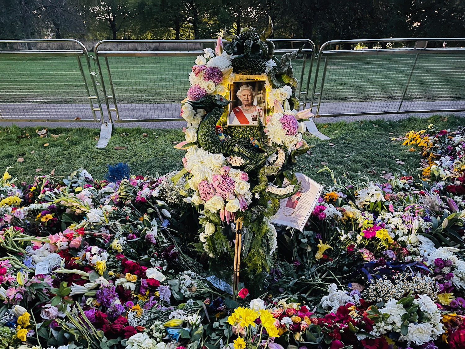 a memorial with flowers and a picture of a man