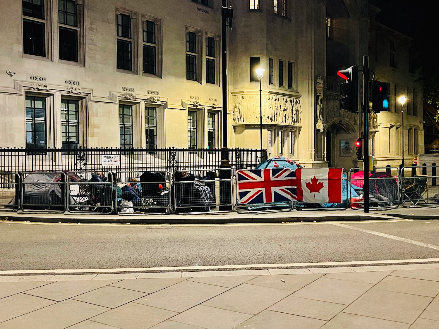 a fence with flags on it and a street light