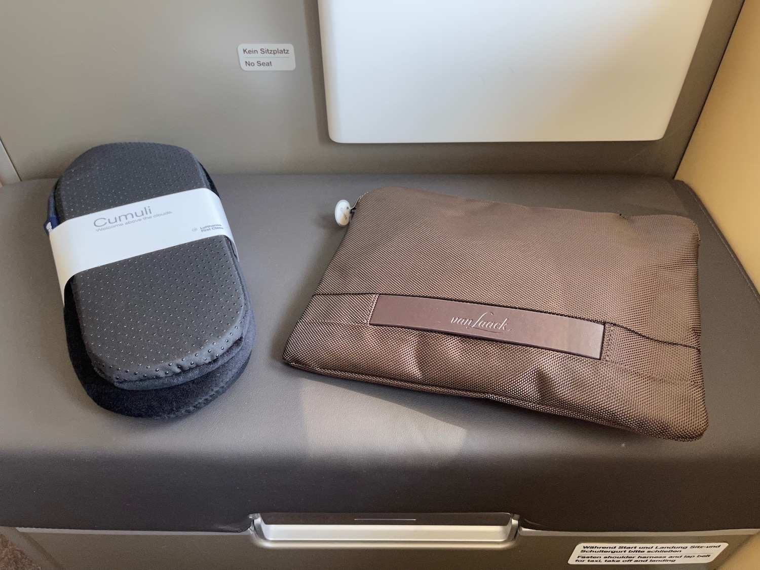 a brown bag and a brown pillow on a grey surface