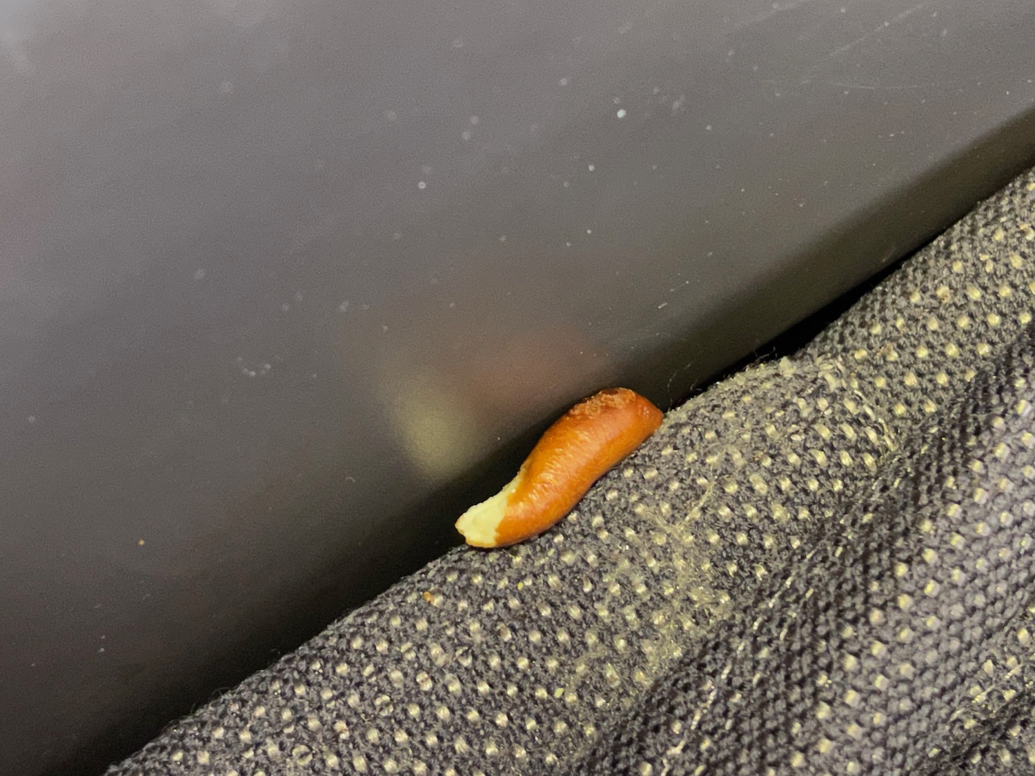 a small orange object on a piece of fabric