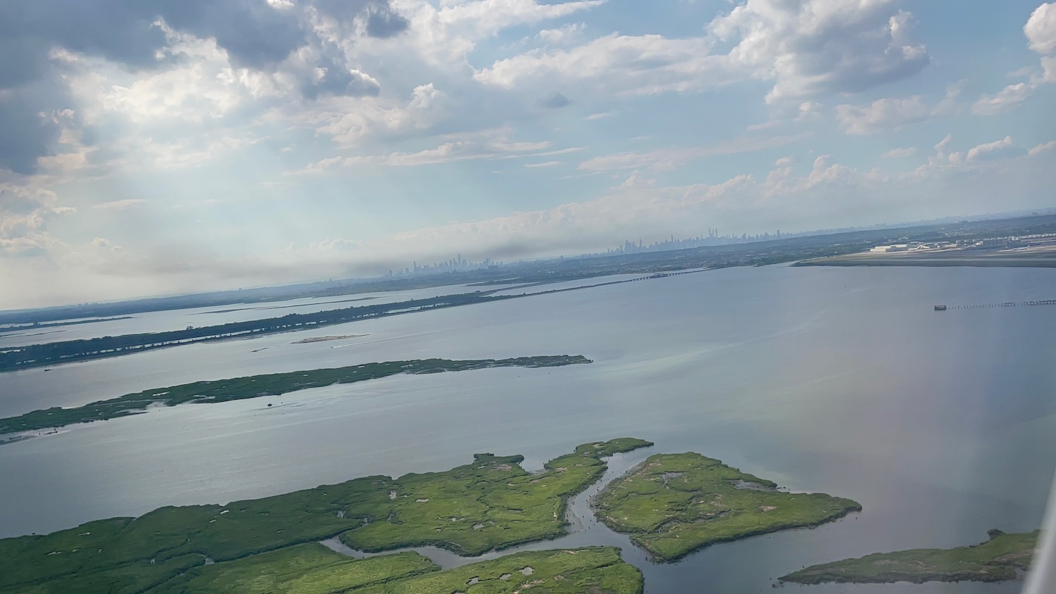 a aerial view of a body of water with land and a city in the background