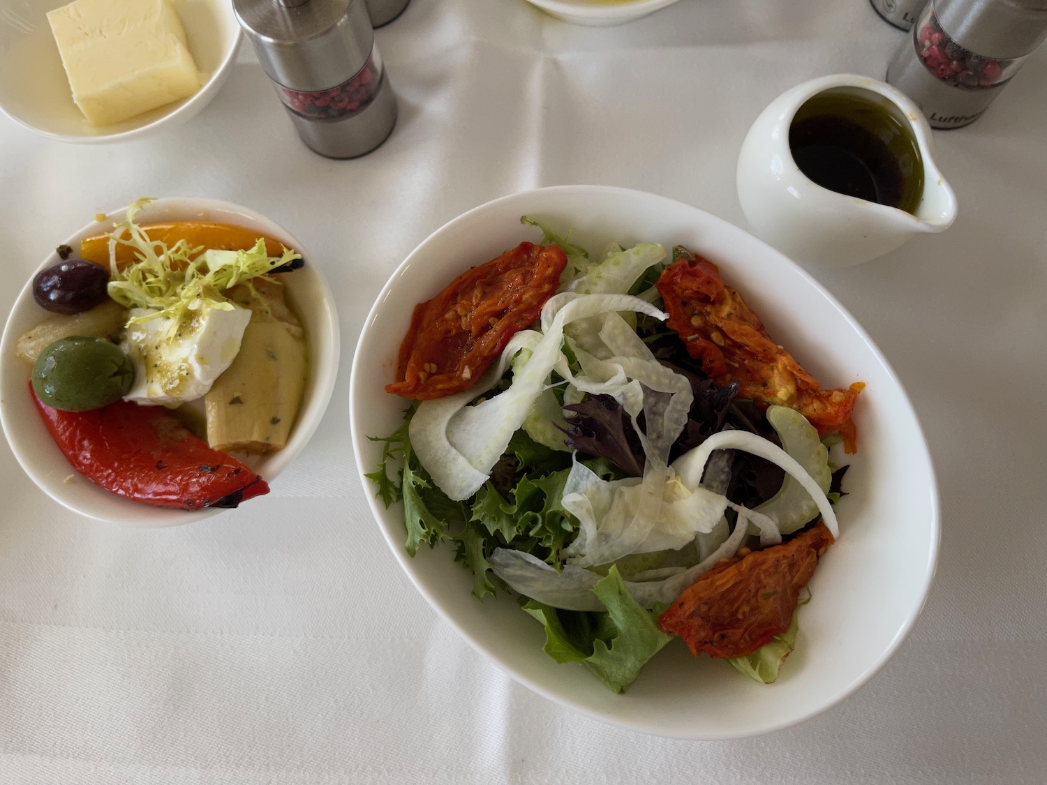 a bowl of salad and other food on a table