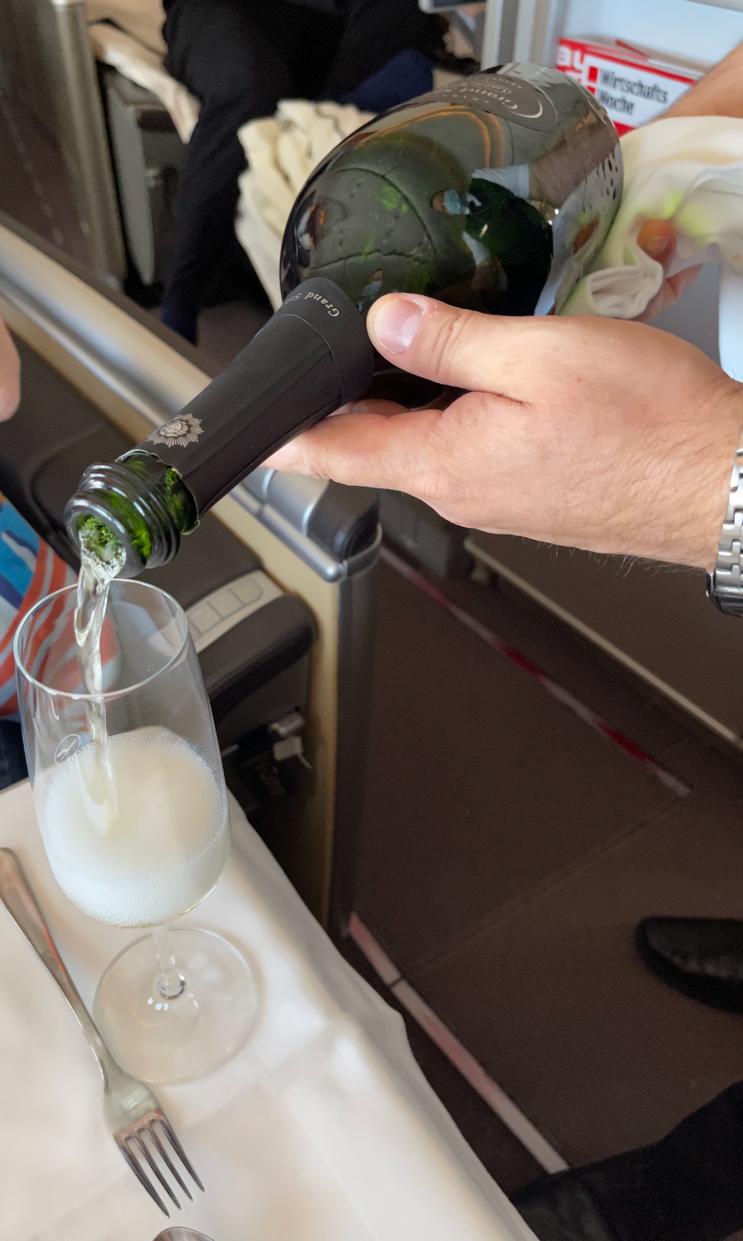 a person pouring a glass of champagne