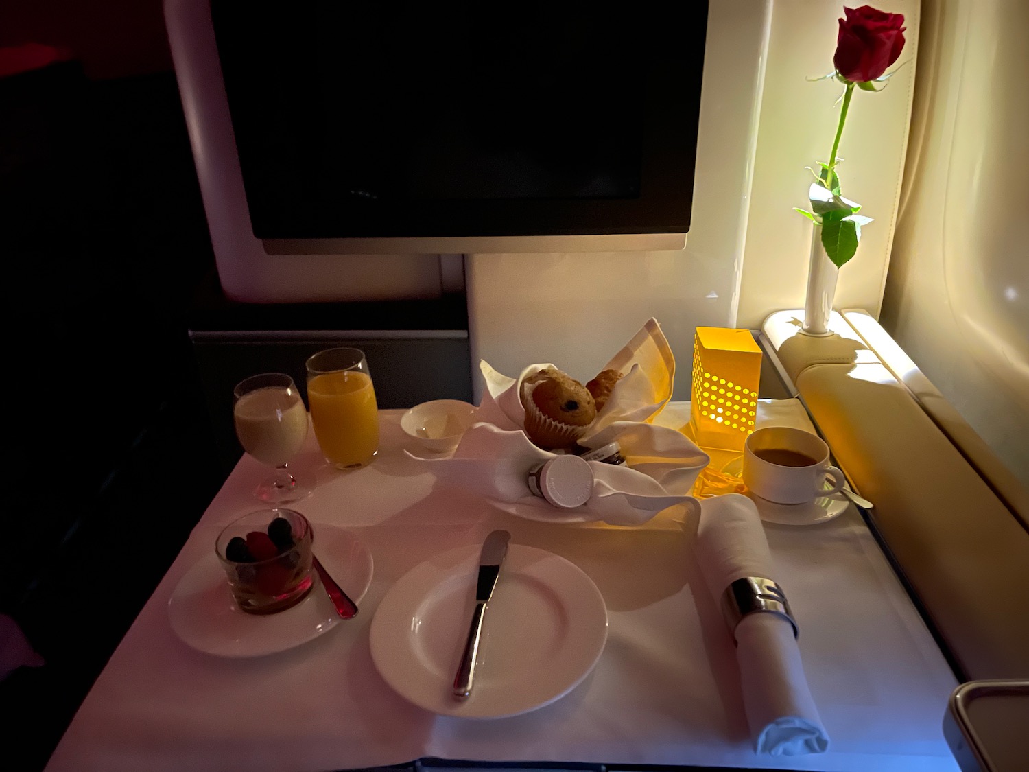 a table with food and a rose on it