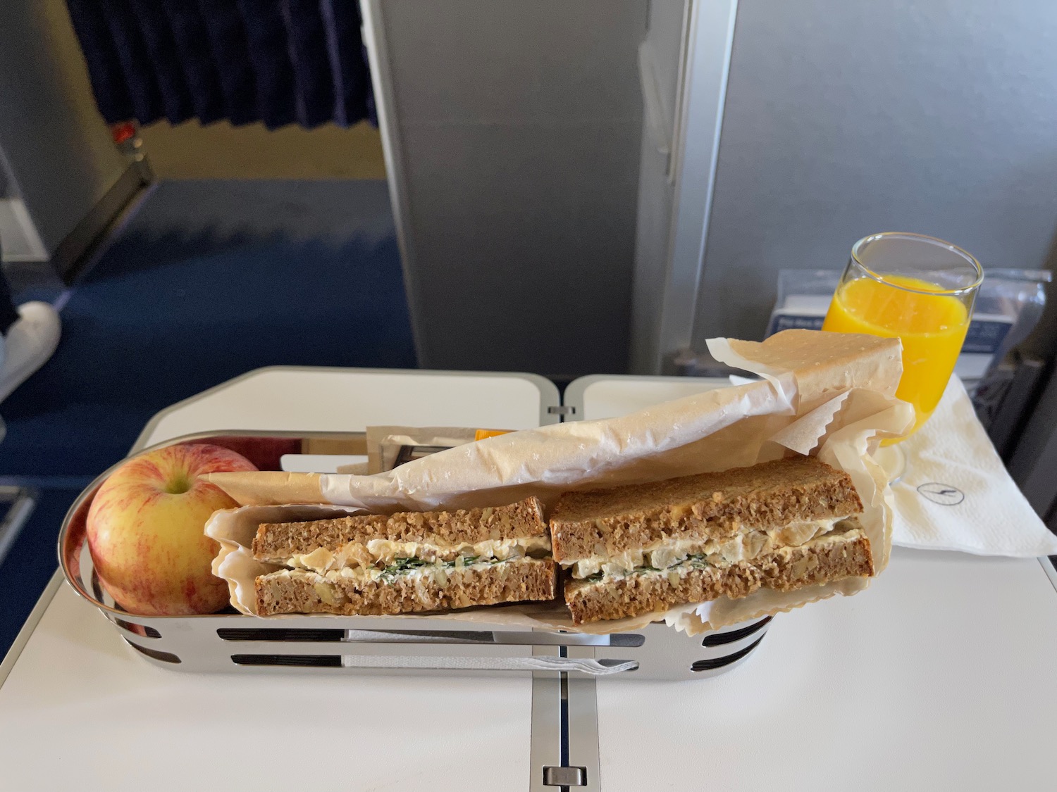 a sandwich and fruit on a tray