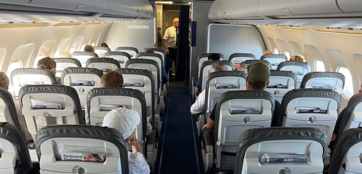 a group of people sitting in an airplane