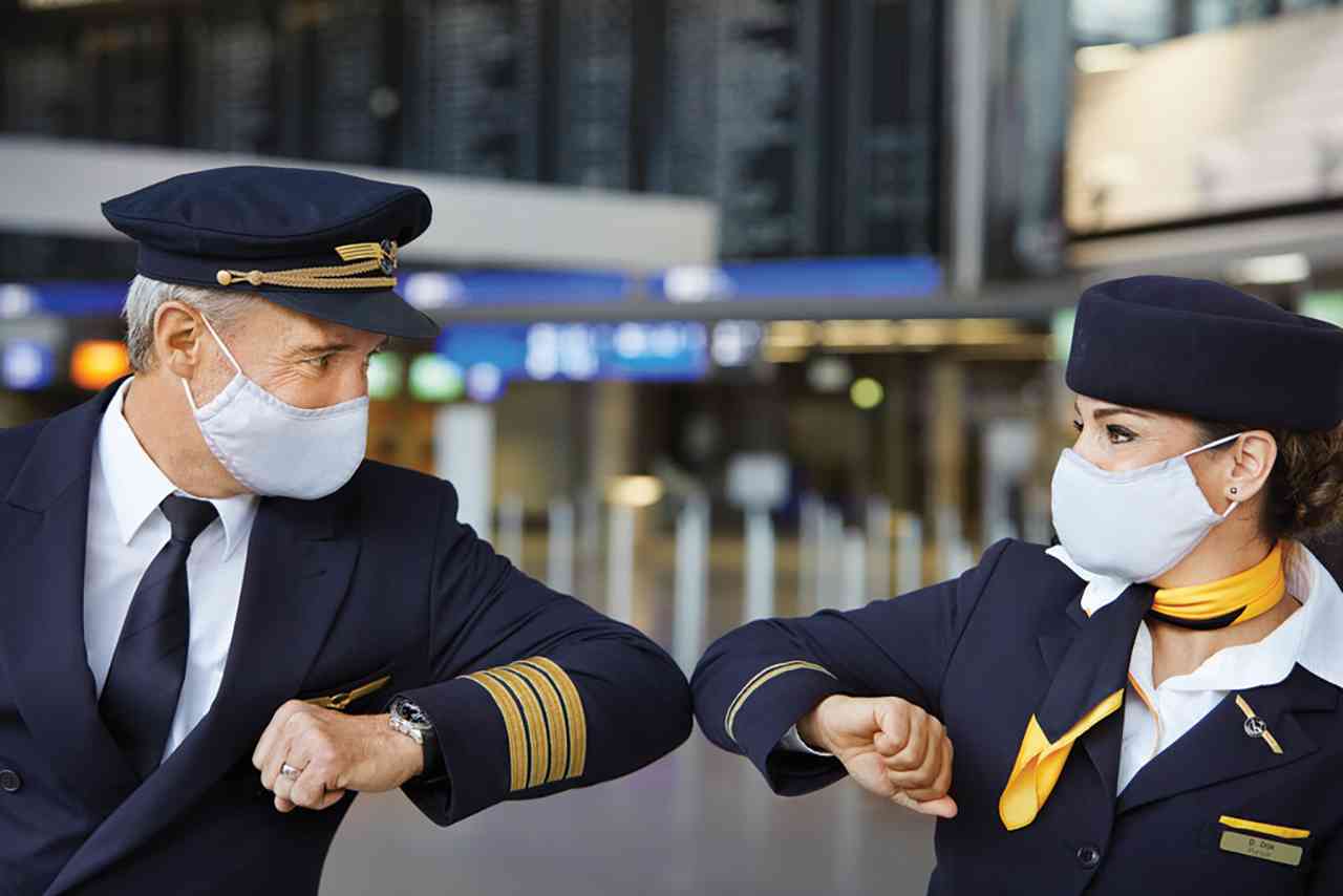 a man and woman wearing face masks