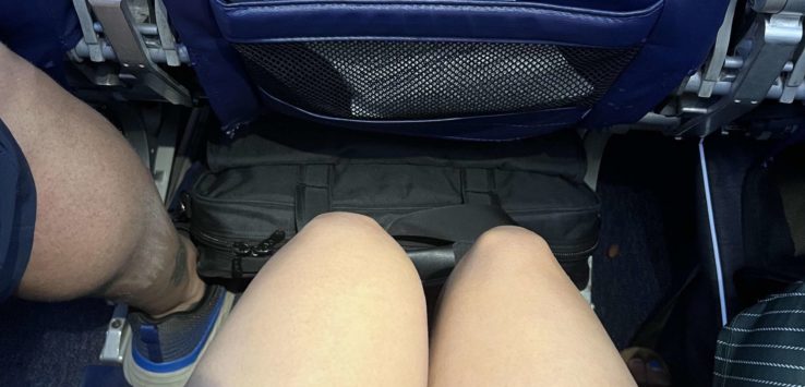 a pair of legs and a pocket in a seat