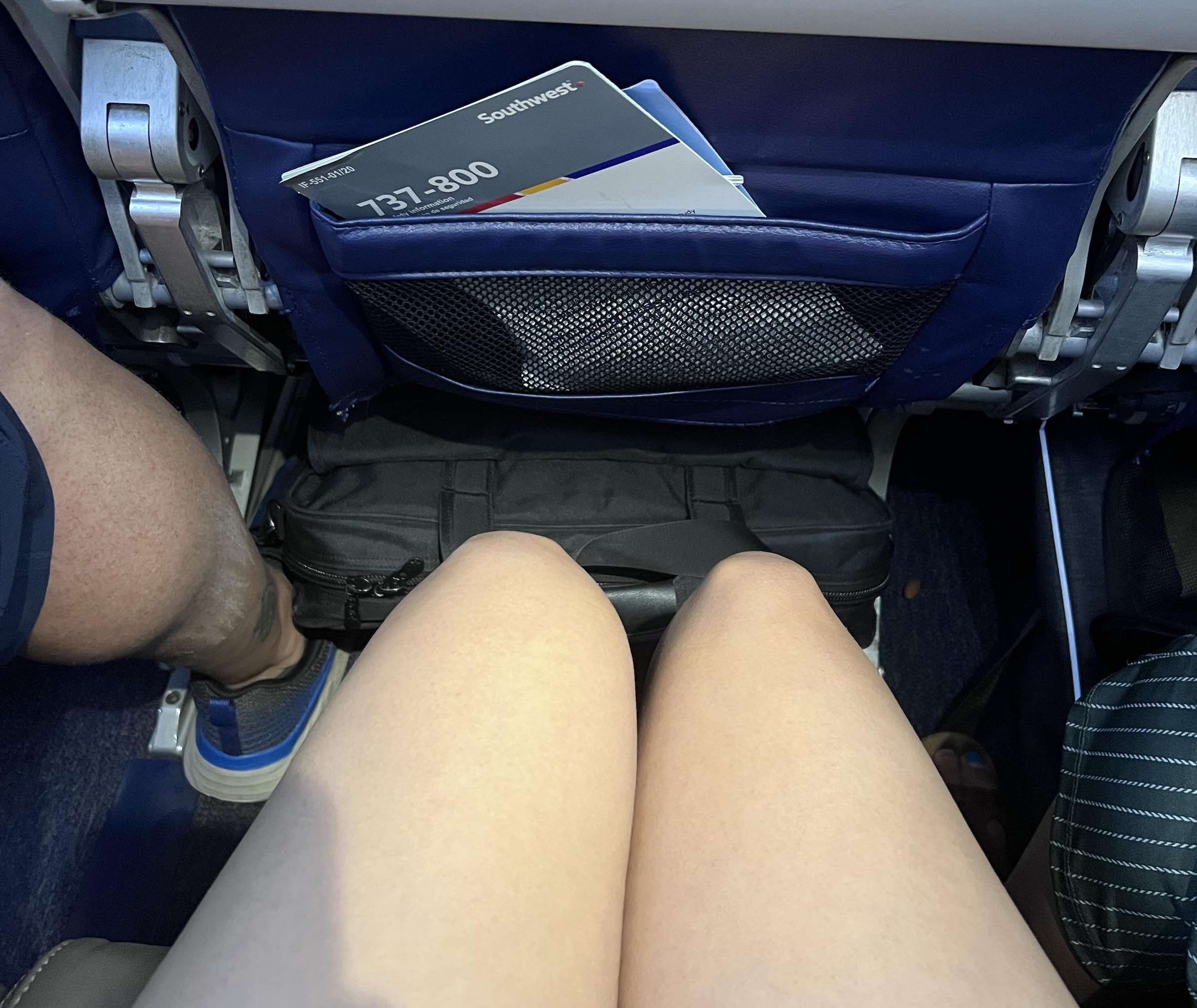 a pair of legs and a pocket in a seat