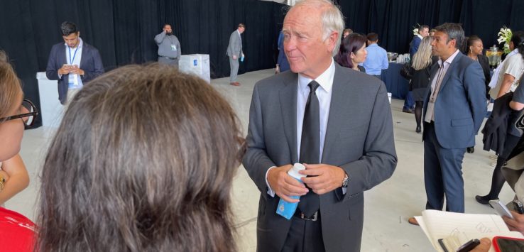 a man in a suit and tie talking to a woman