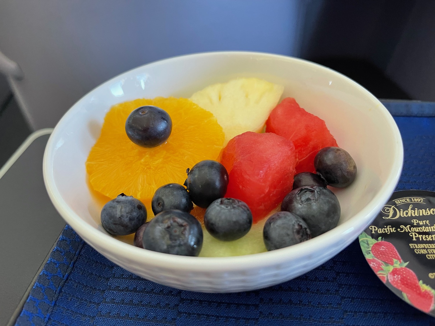 a bowl of fruit on a place mat