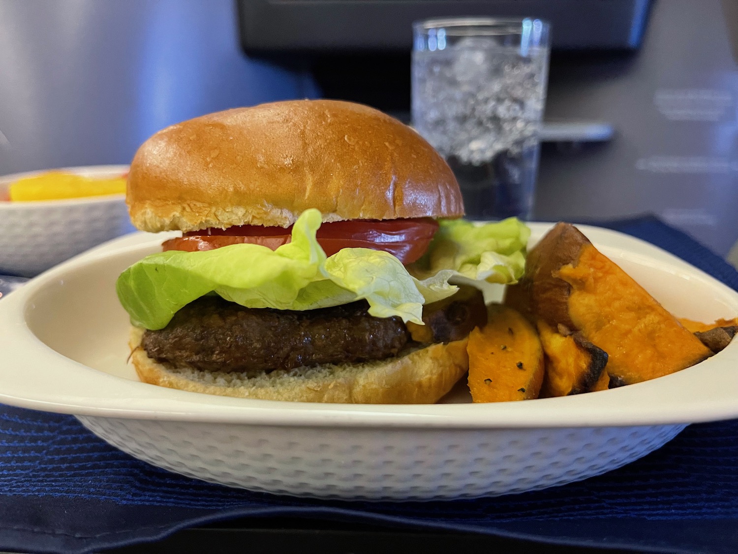 a hamburger and sweet potatoes on a plate