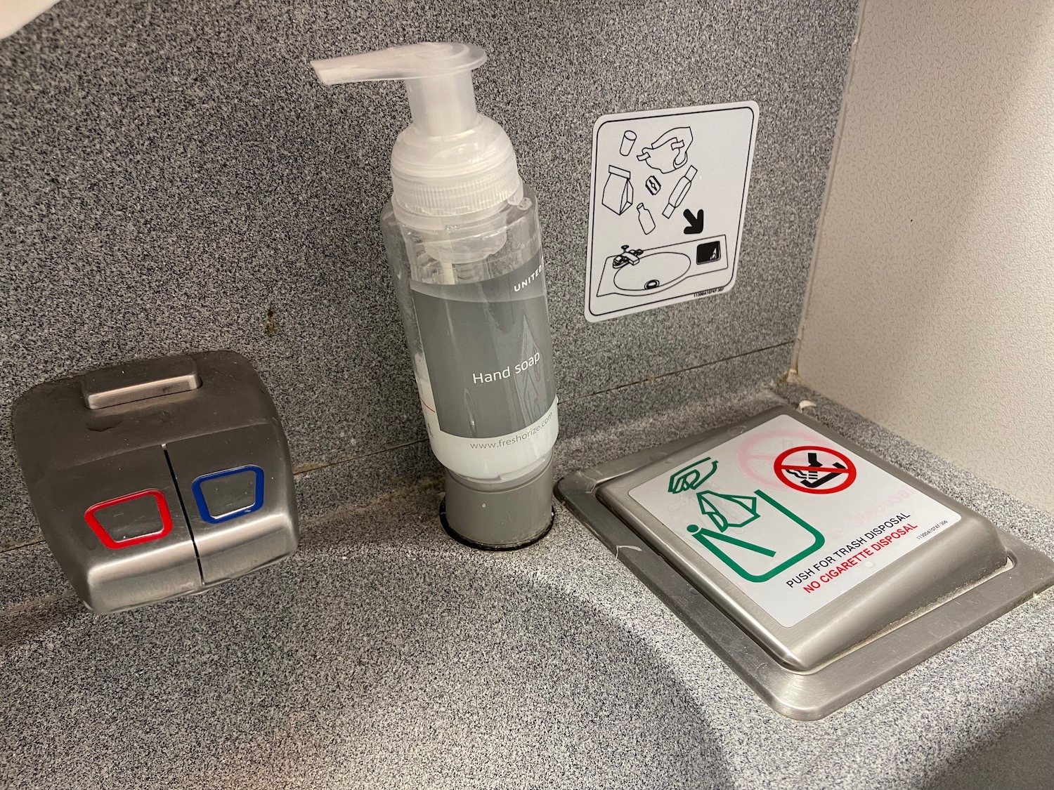 a hand sanitizer and a button on a counter