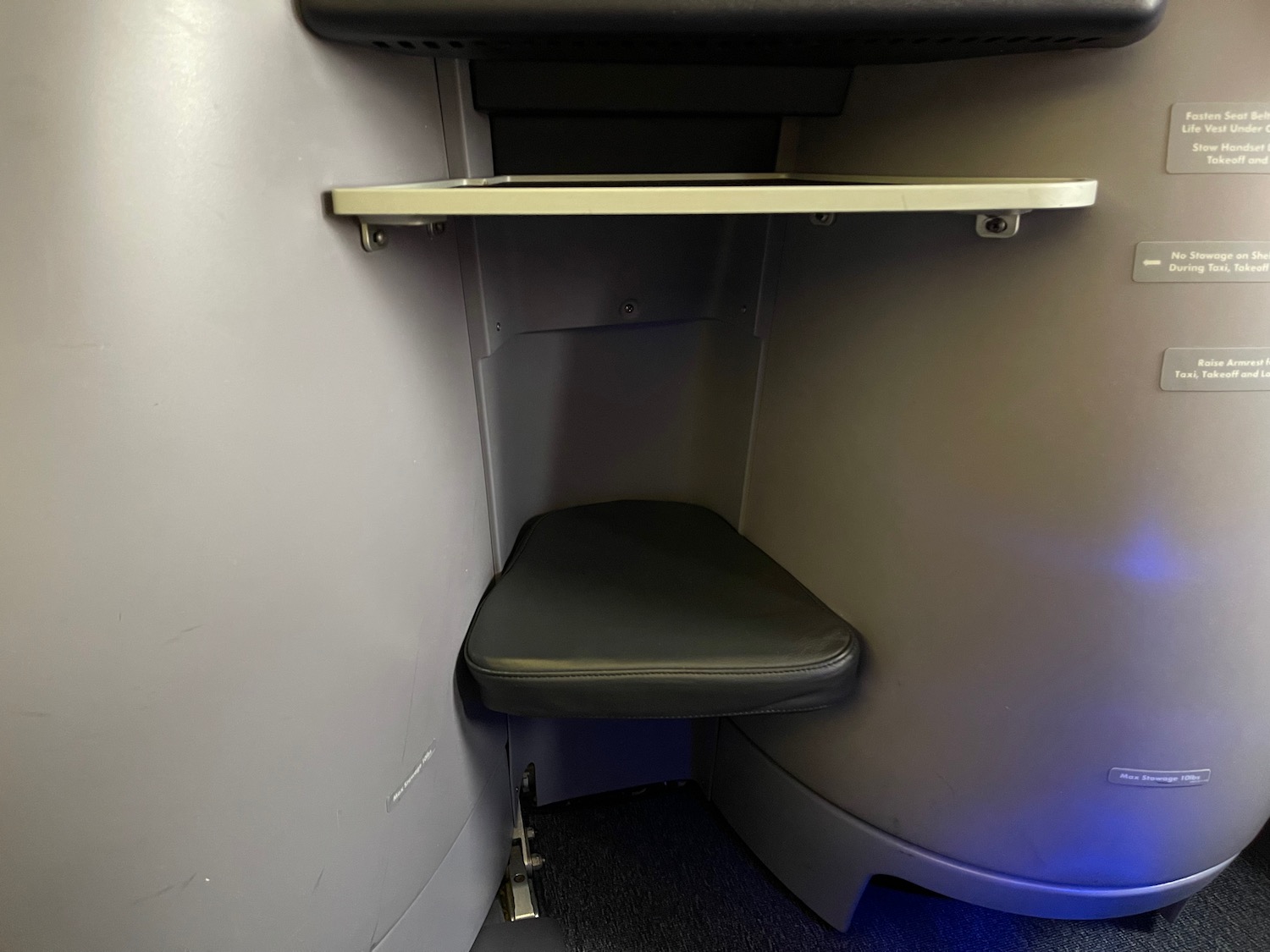 a seat in a corner of a plane