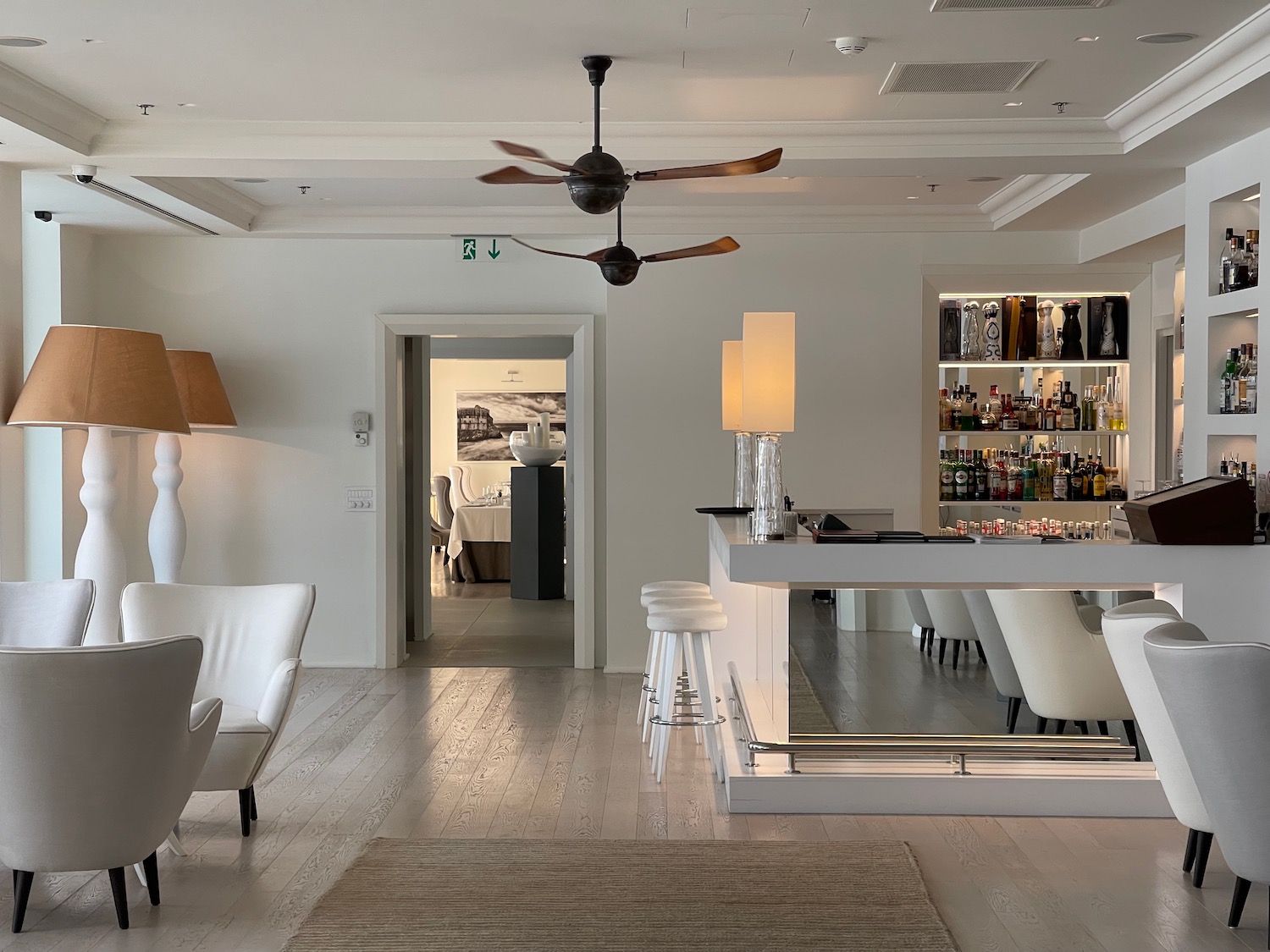 a room with a bar and a ceiling fan