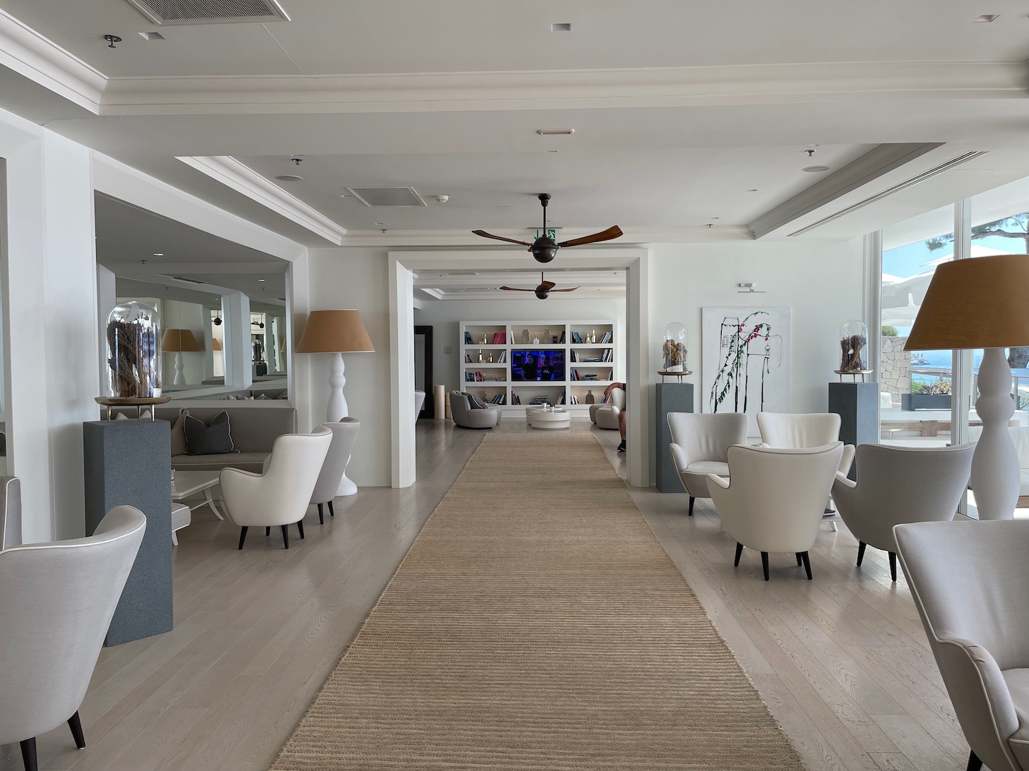 a room with white furniture and a brown carpet