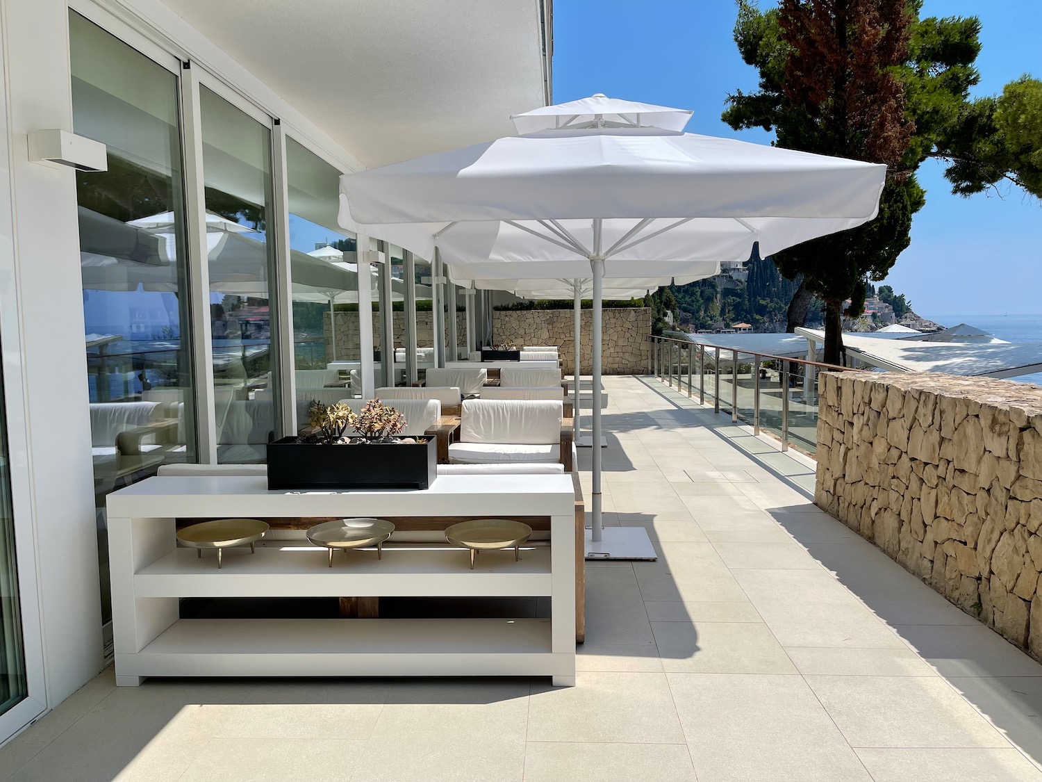 a white table and umbrellas on a patio