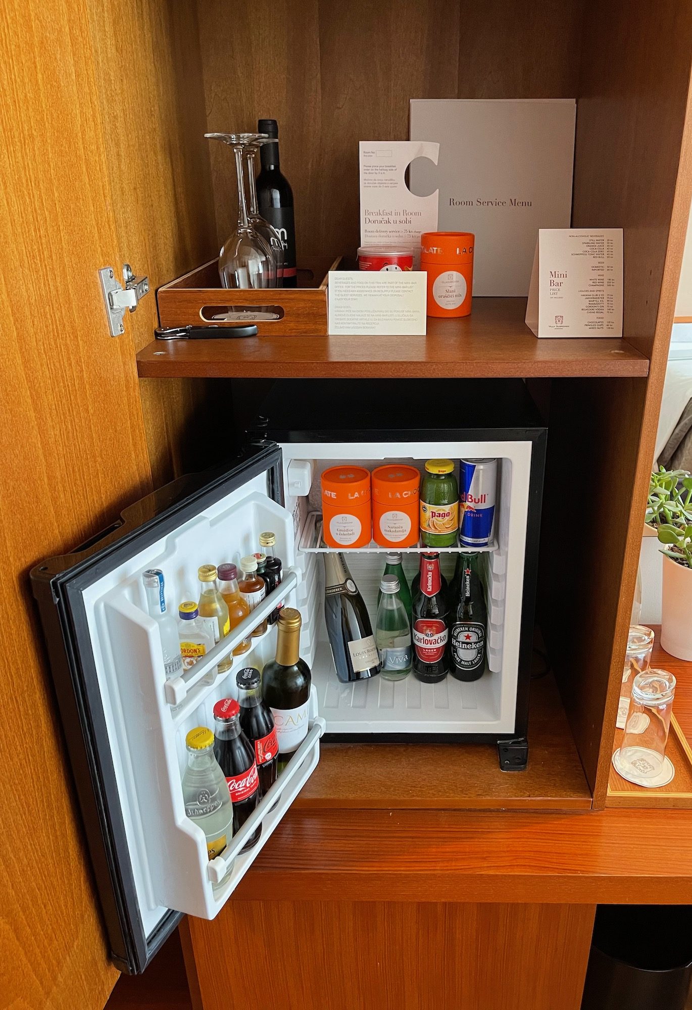 a mini fridge with bottles and alcohol inside