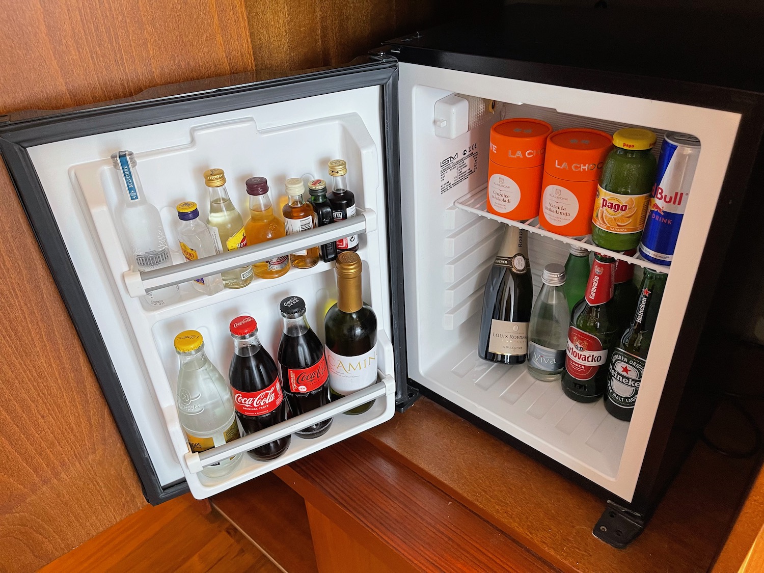 a mini fridge with bottles of drinks