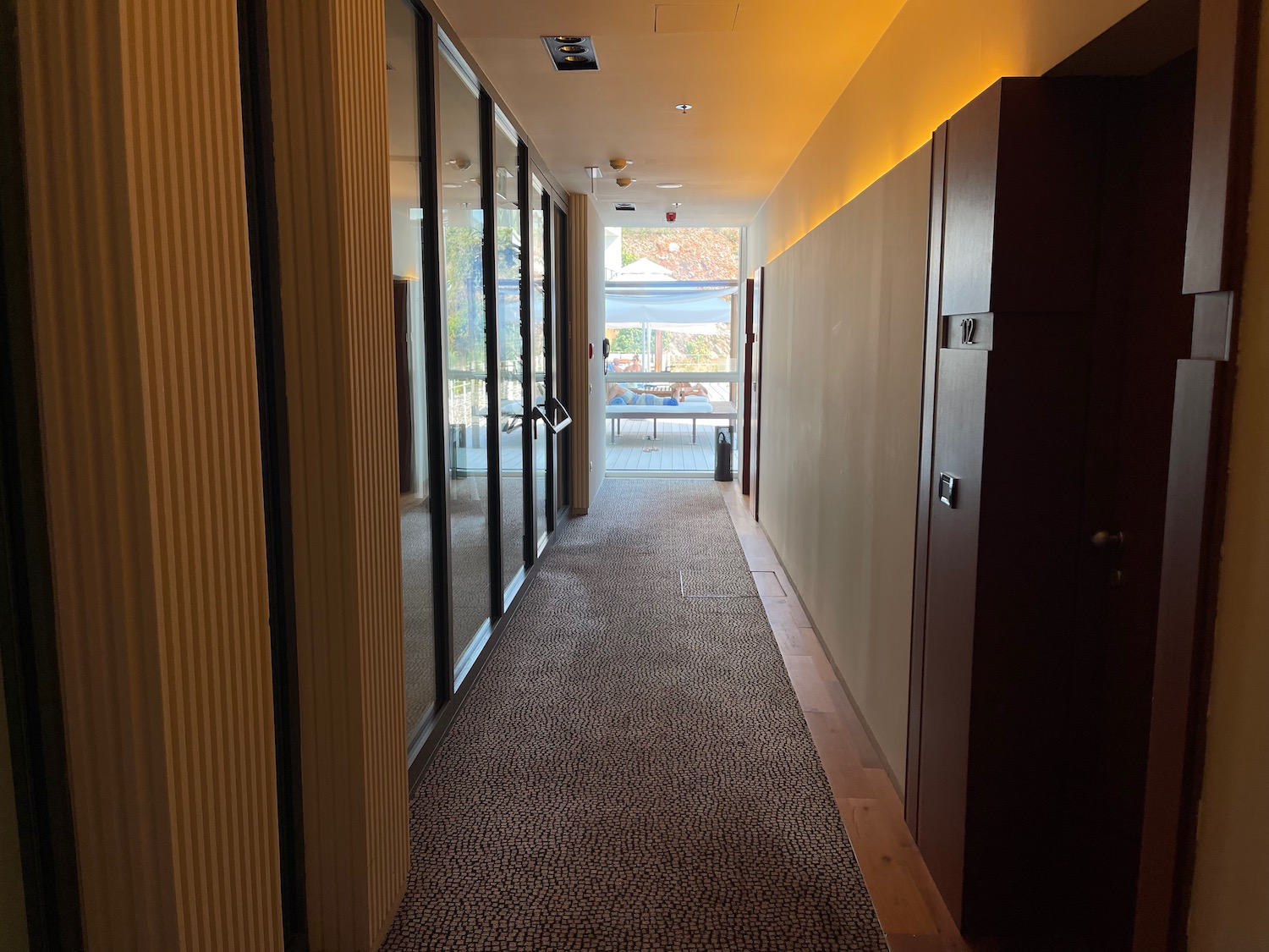 a hallway with glass doors and a door on the wall