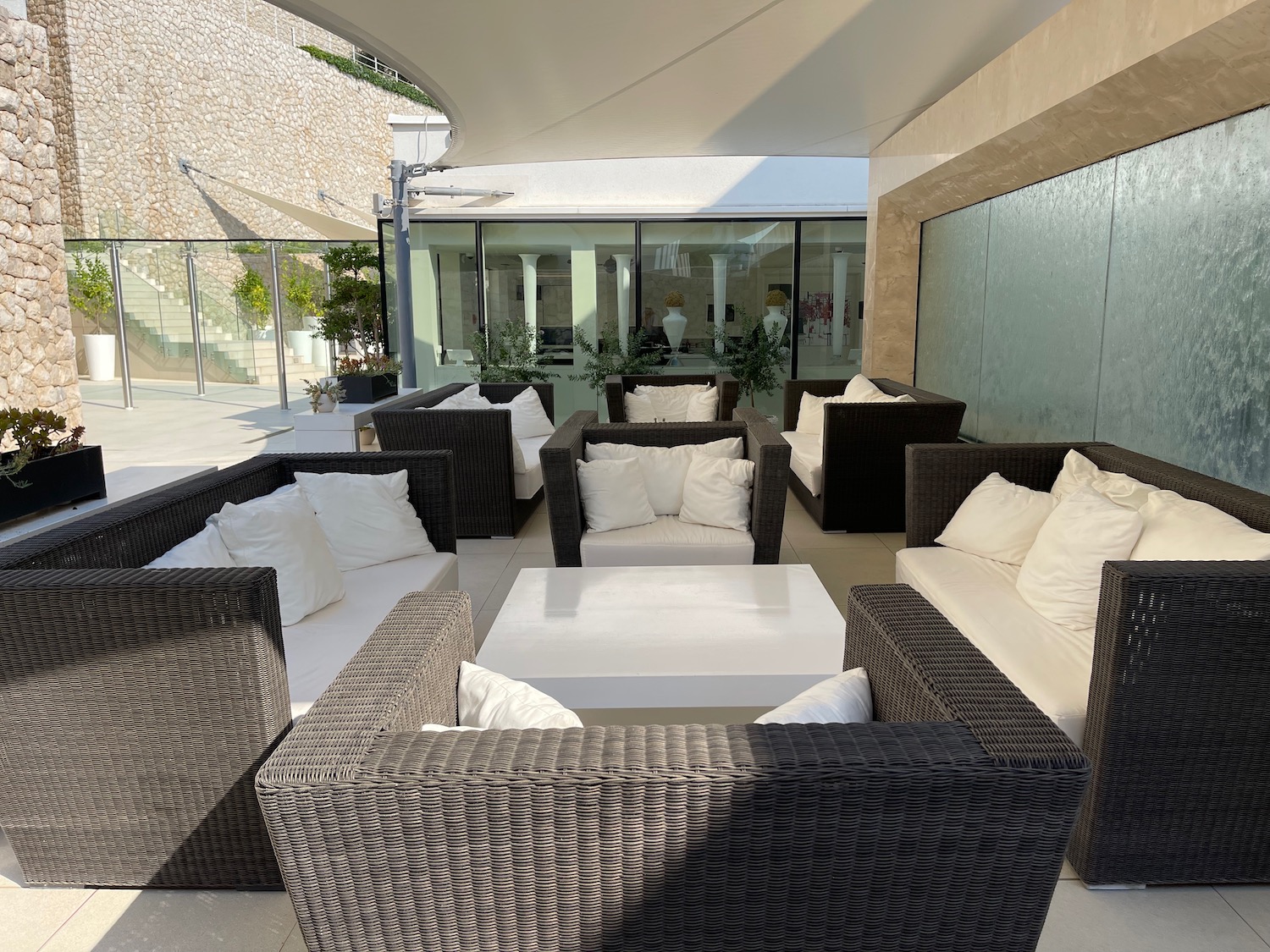 a patio with white furniture and a white table