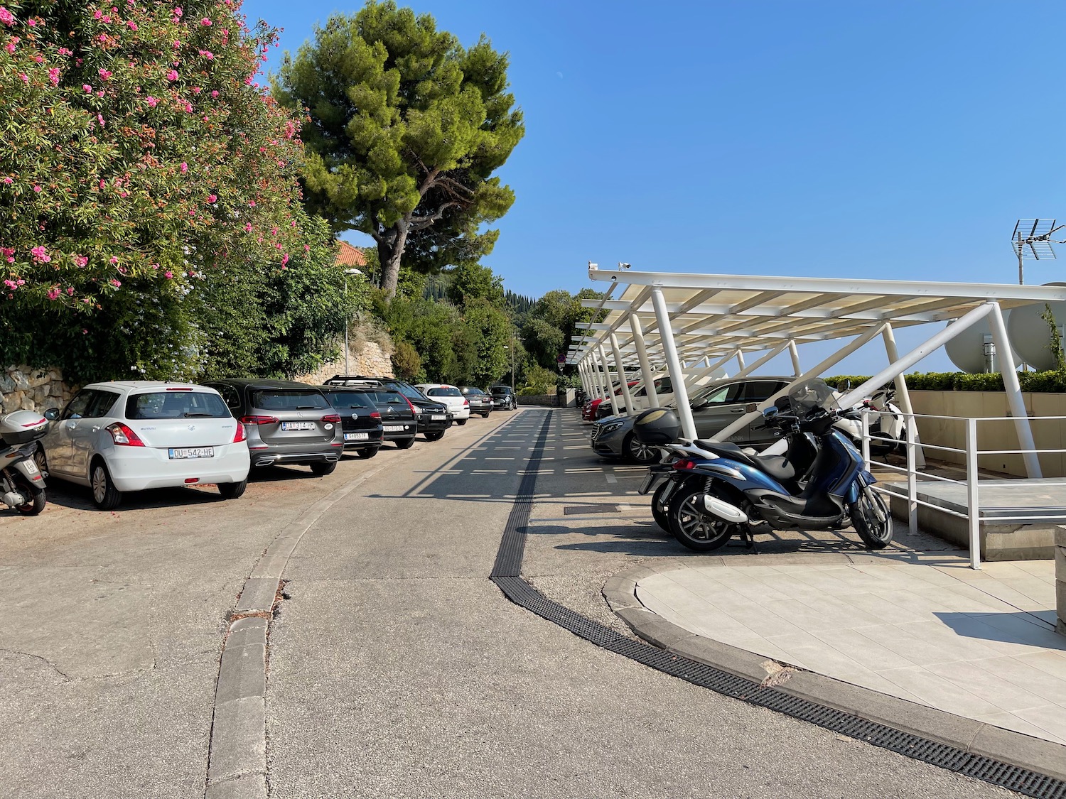 a parking lot with cars and a scooter