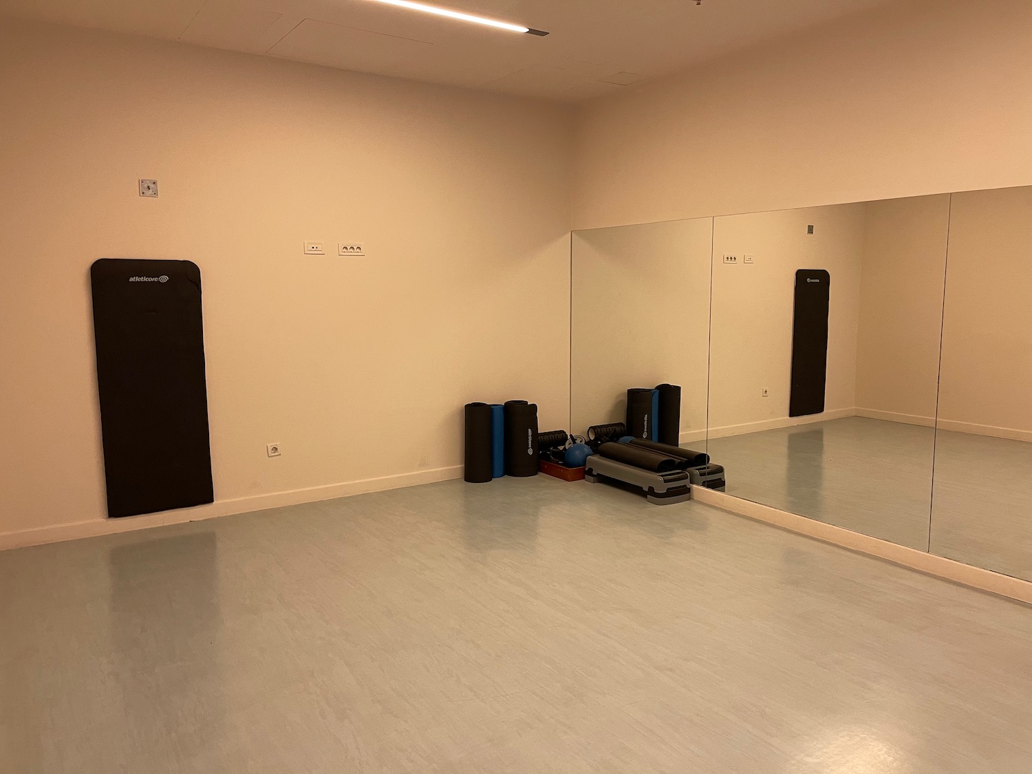 a room with a mirror and exercise equipment