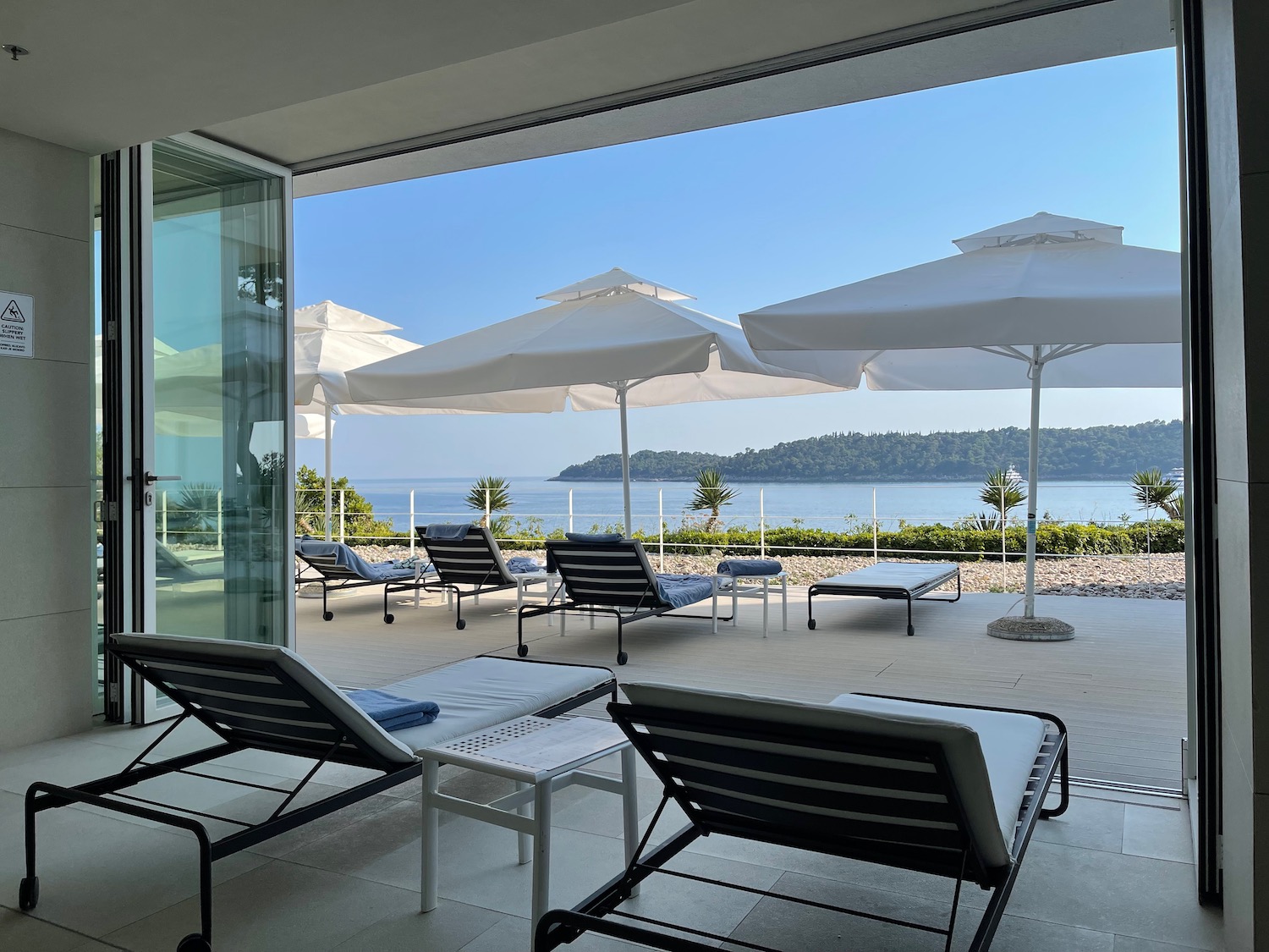 a beach chairs and umbrellas on a patio