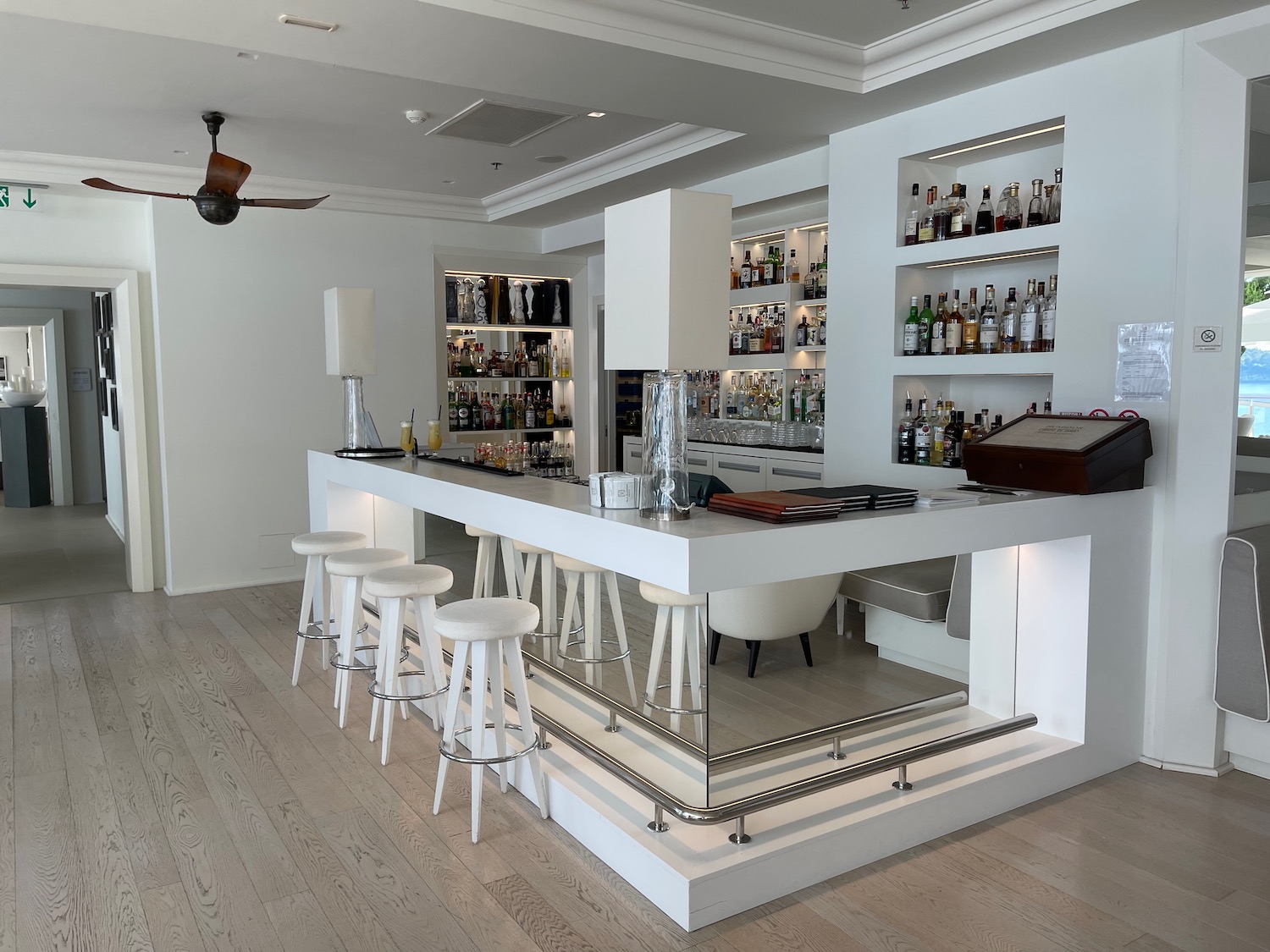 a bar with shelves and bottles of alcohol