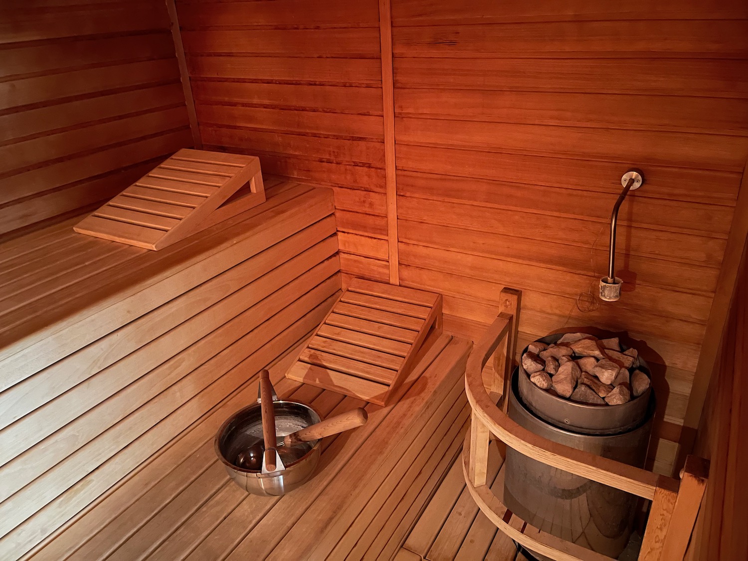a sauna with a bucket of rocks and a bucket of stones
