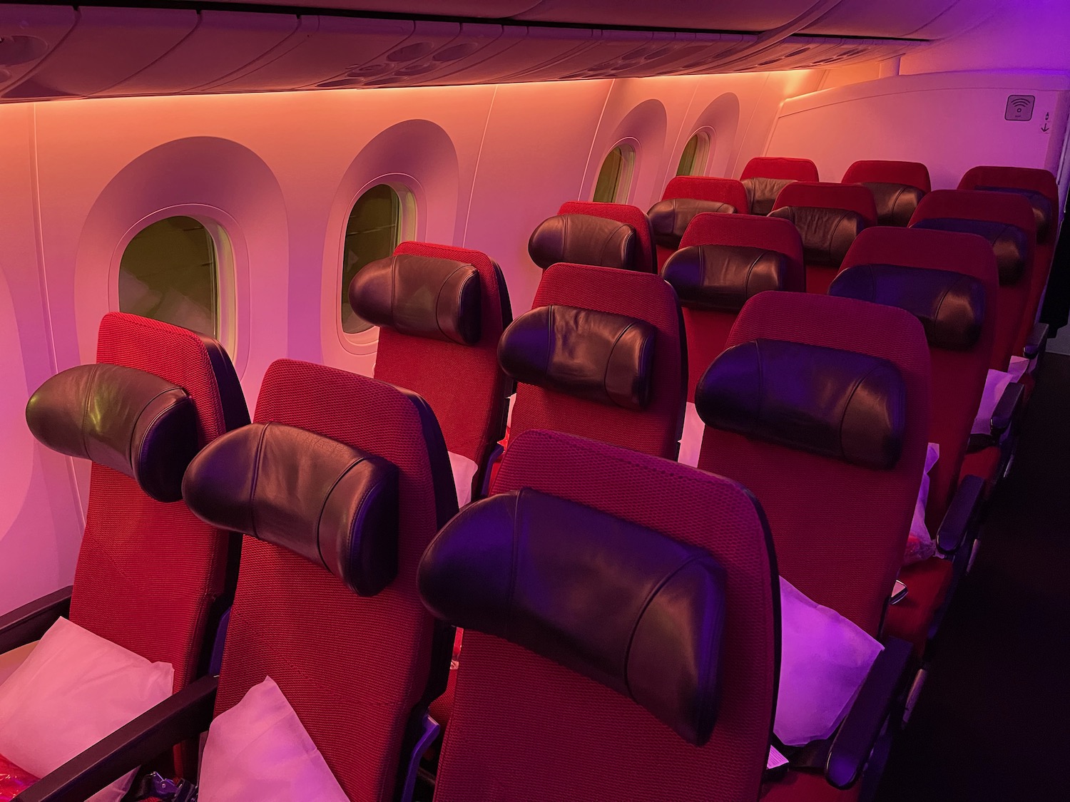 a row of red and black seats on an airplane