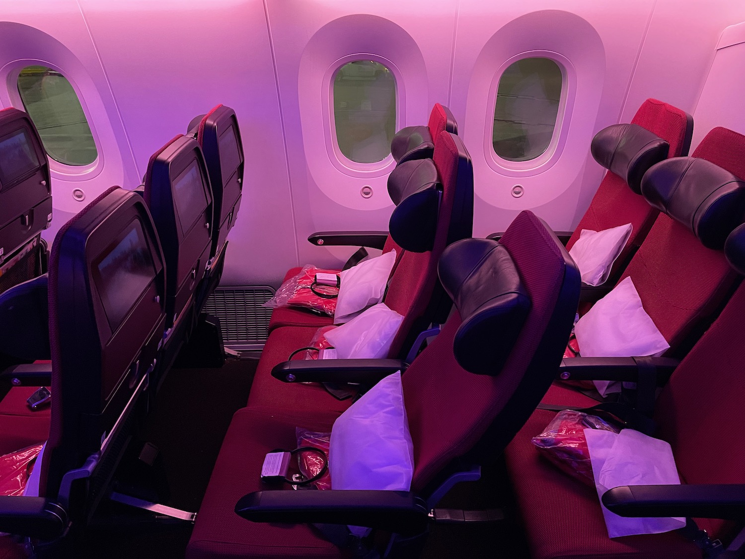 a row of red seats in an airplane