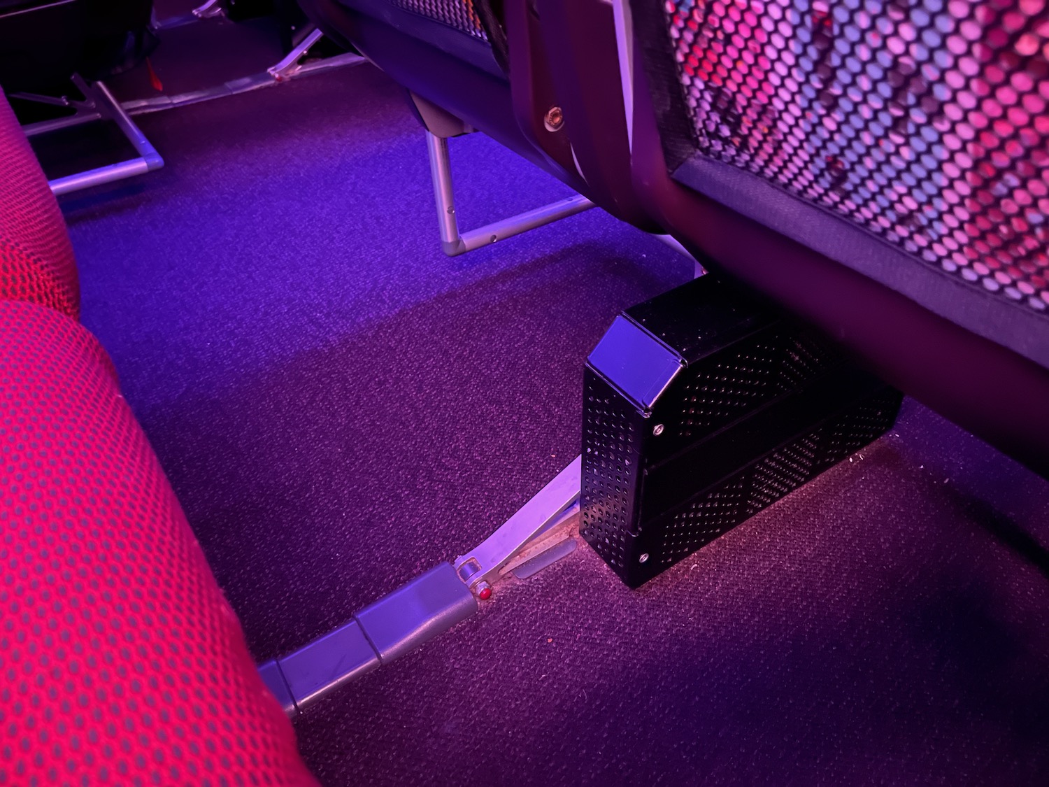 a seat with a metal object on the floor