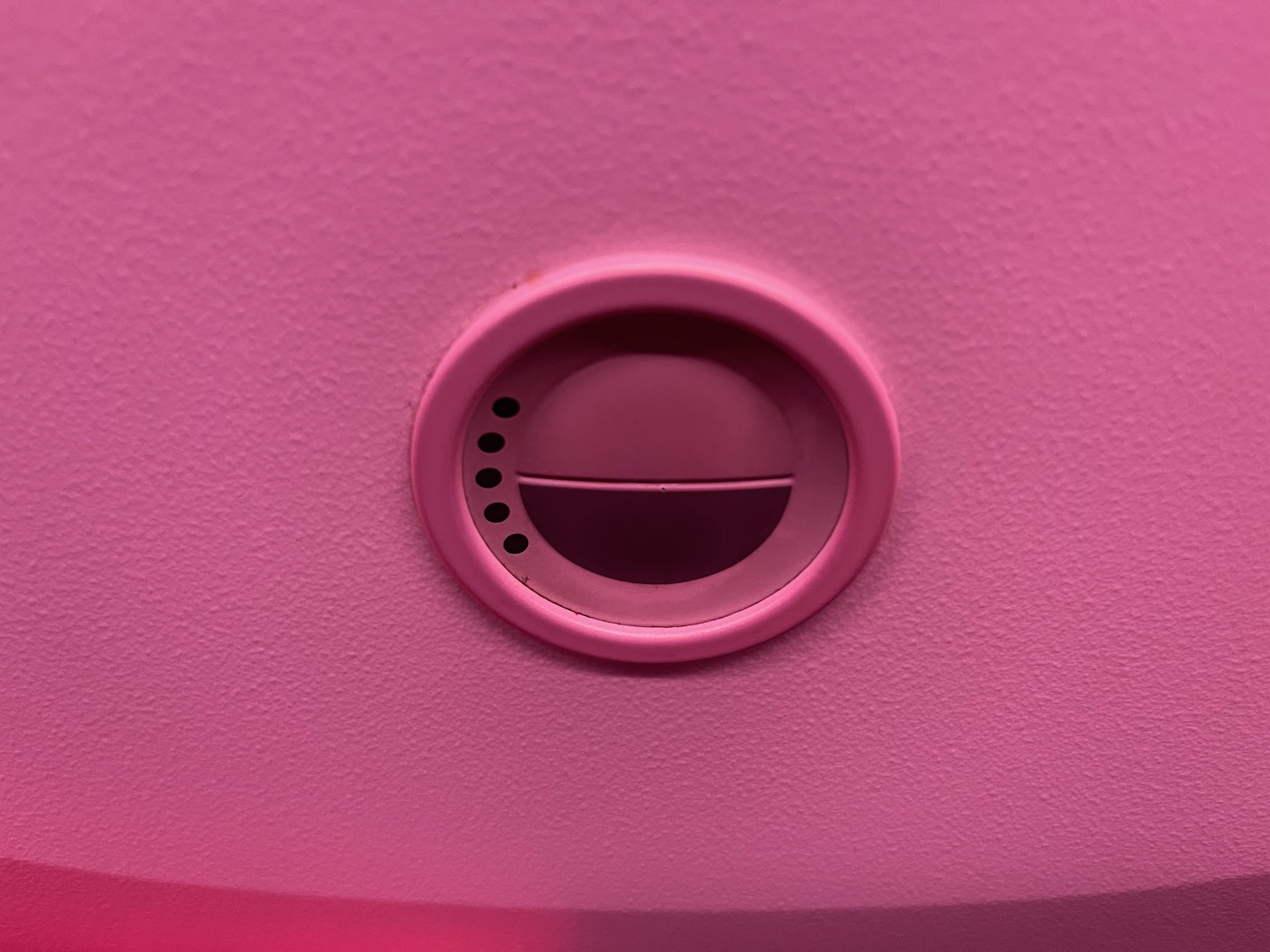 a pink object with holes