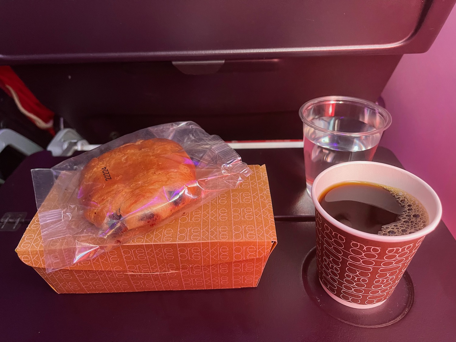 a pastry and a cup of coffee on a tray