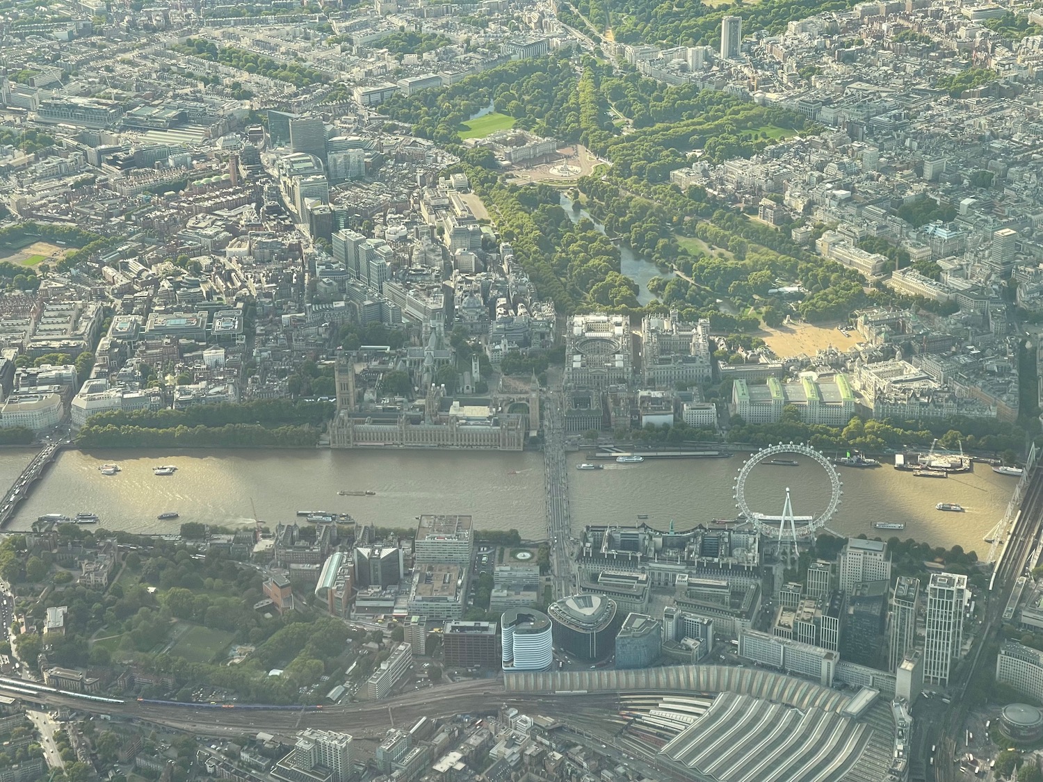 a city with a river and a ferris wheel