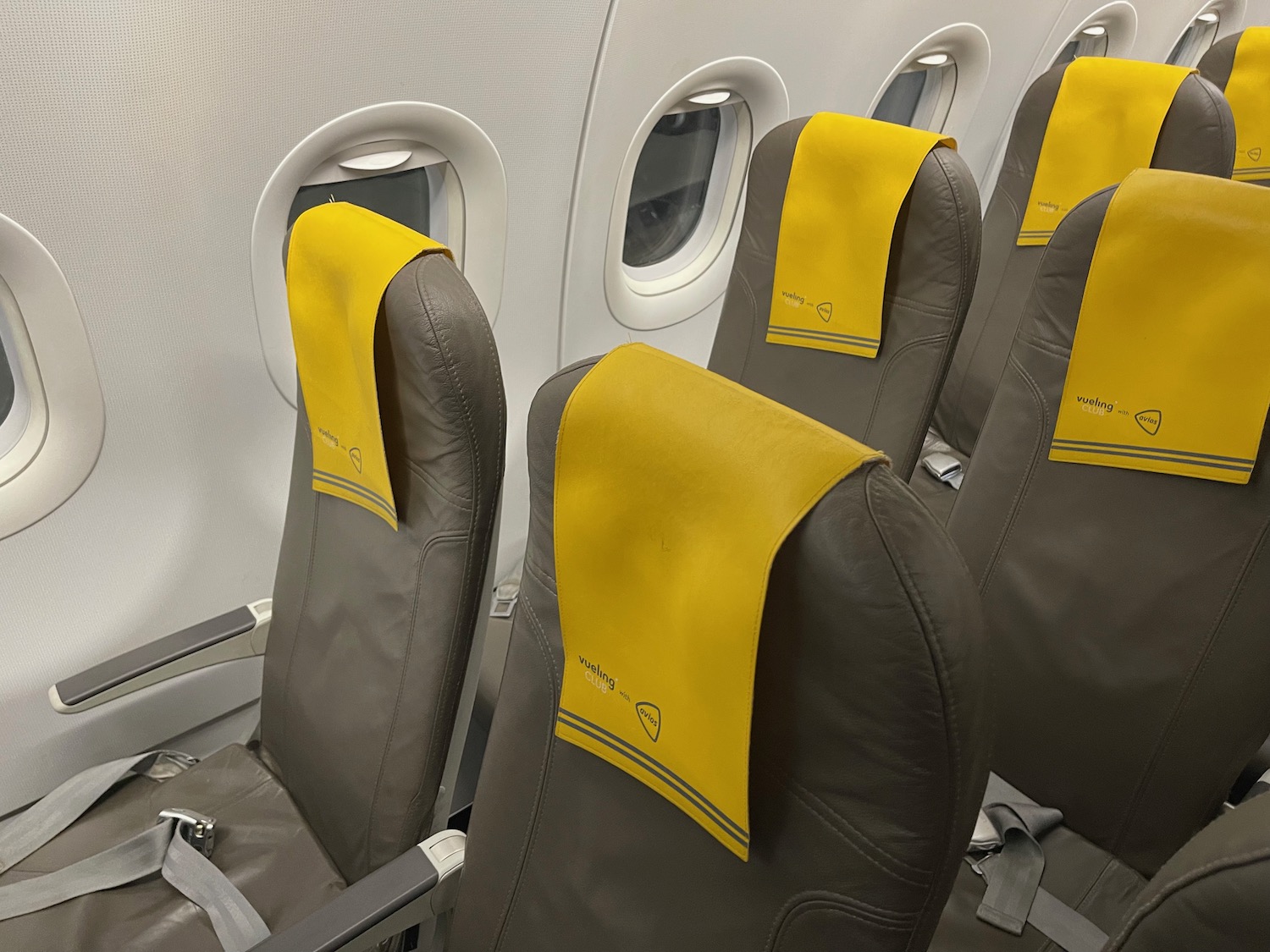 a row of seats with yellow cloth on them