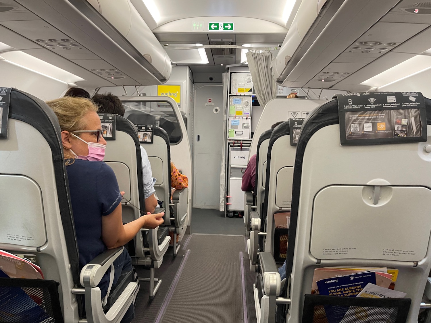 a woman wearing a mask on a plane